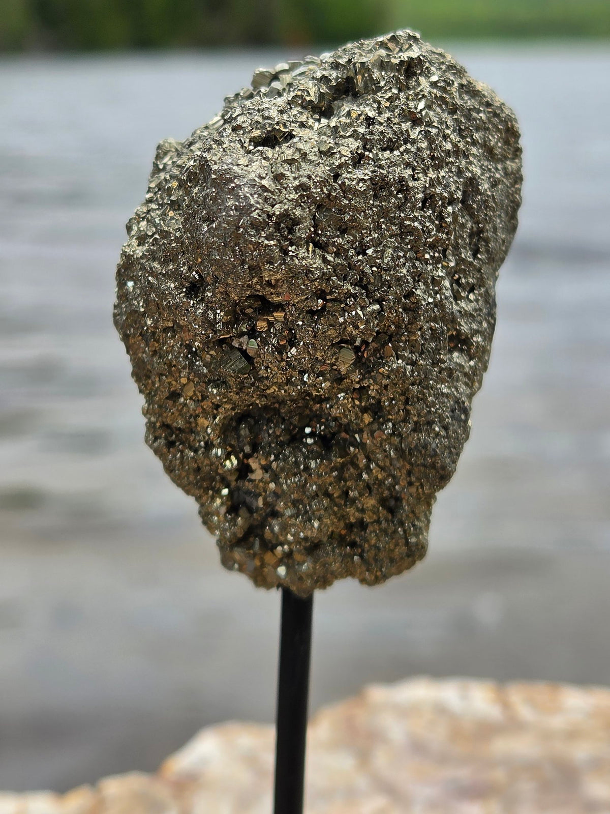 Pyrite cluster on stand angled view