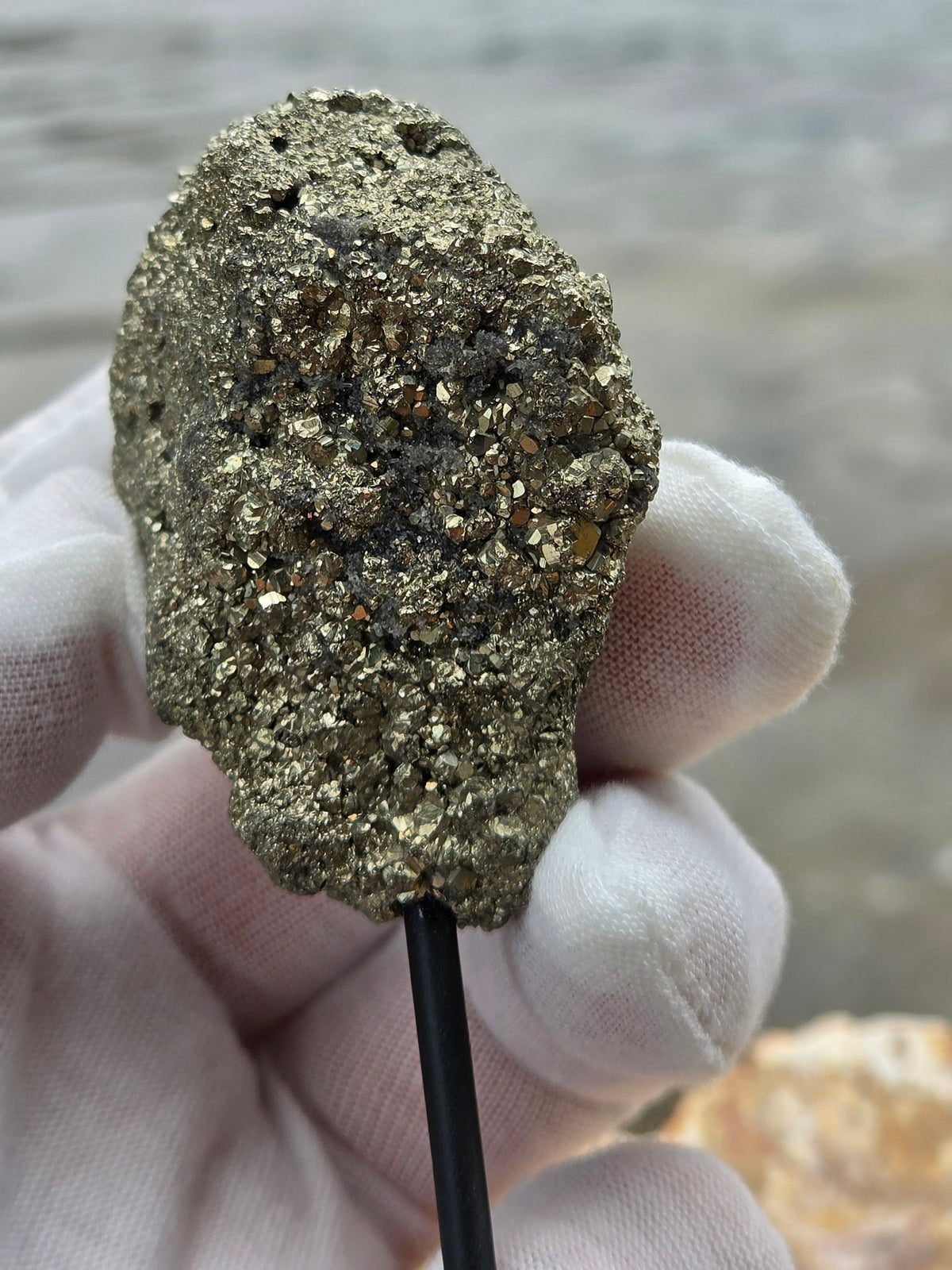 Pyrite druzy held in hand closeup