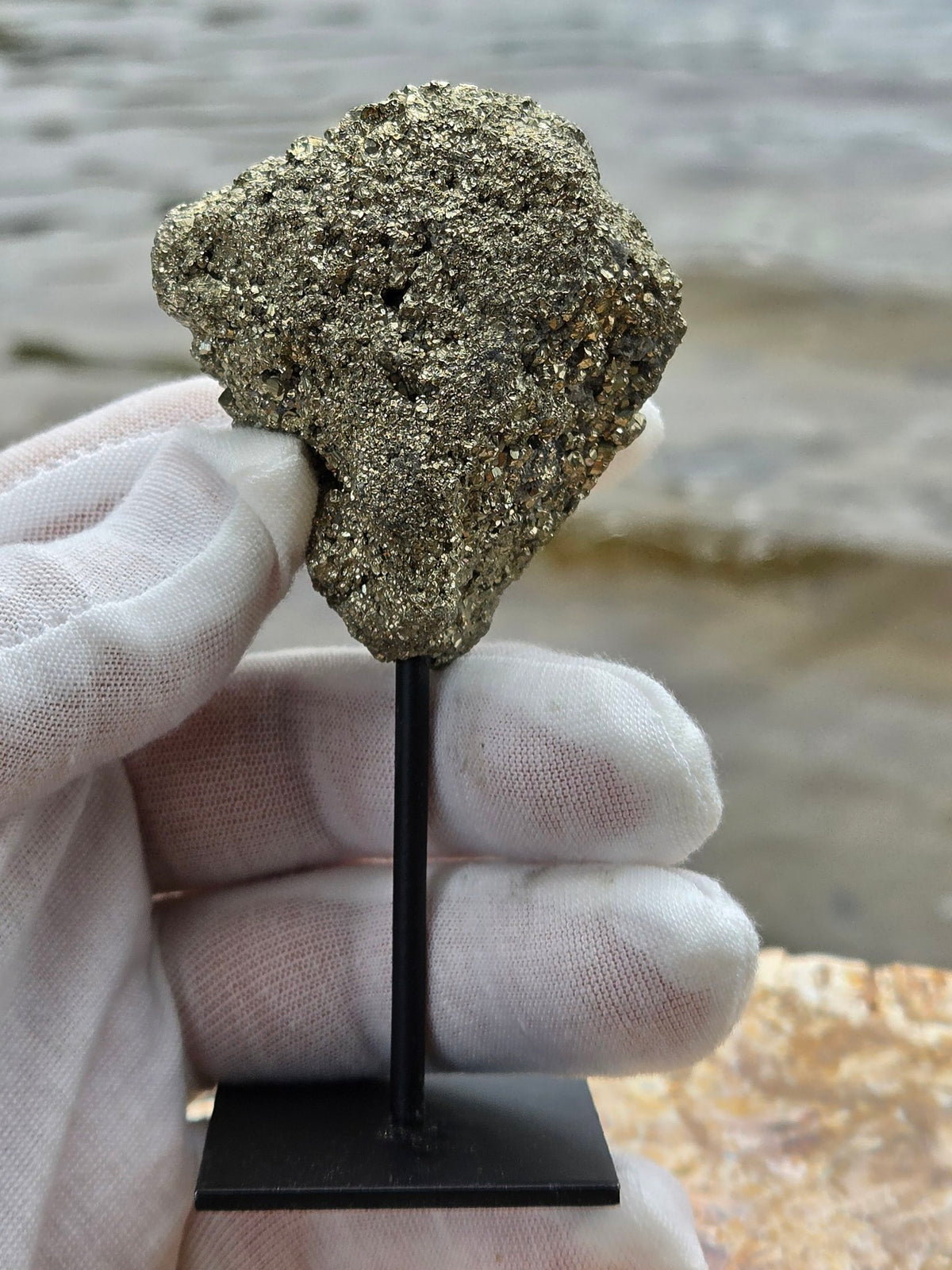 Pyrite druzy held in hand