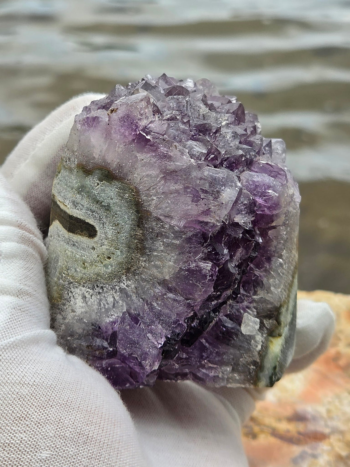 Amethyst crystal cluster held in hand