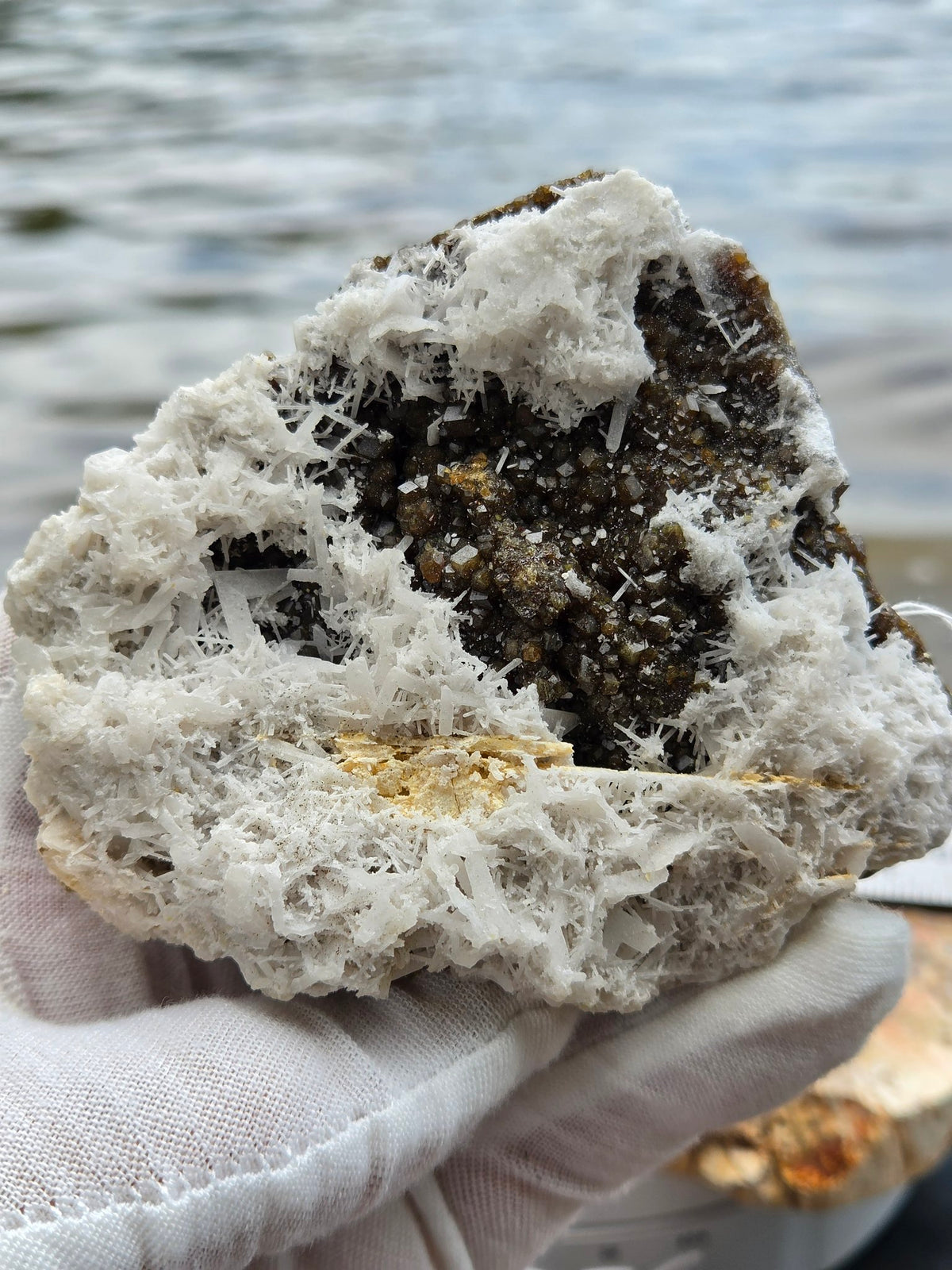 Garnet with scolecite and calcite held in hand