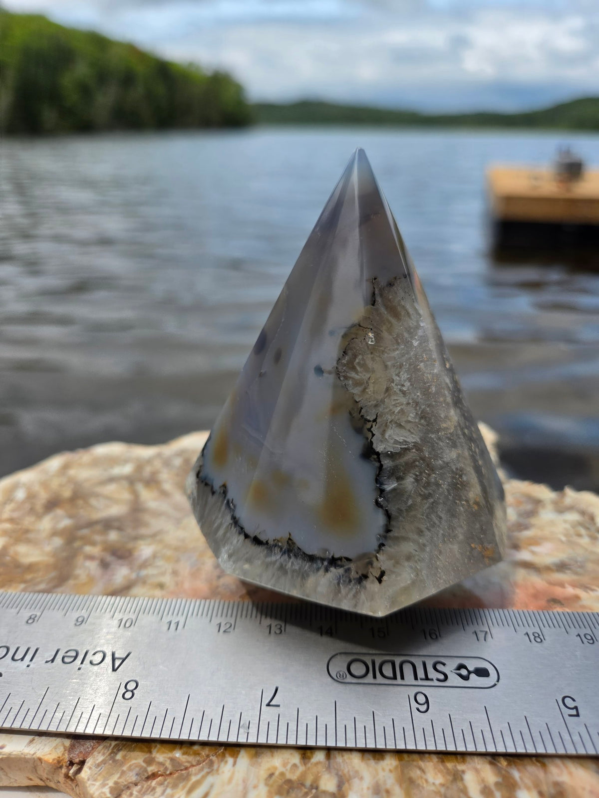 Agate tree held in hand for scale