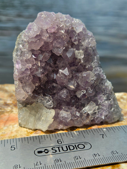 Freestanding amethyst cluster with calcite inclusion, front view