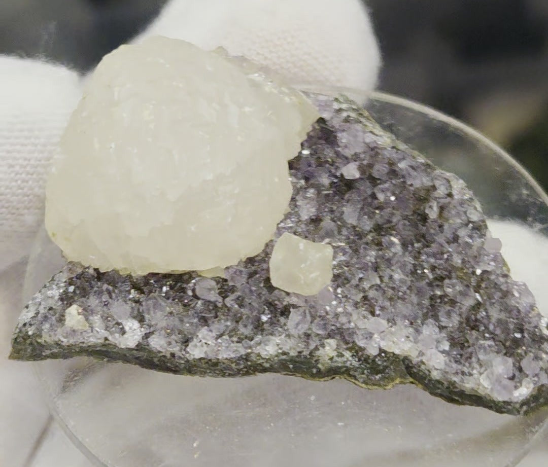 Botryoidal calcite on amethyst cluster specimen