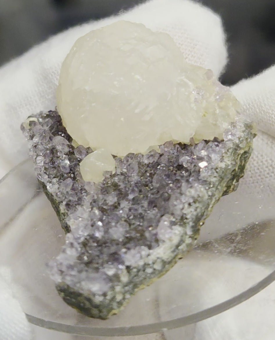 Botryoidal calcite on amethyst cluster specimen
