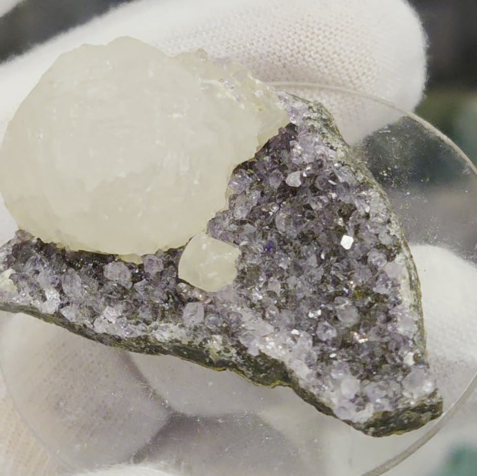 Botryoidal calcite on amethyst cluster specimen