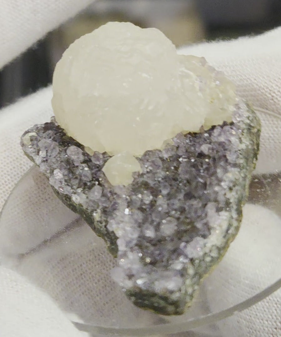 Botryoidal calcite on amethyst cluster specimen