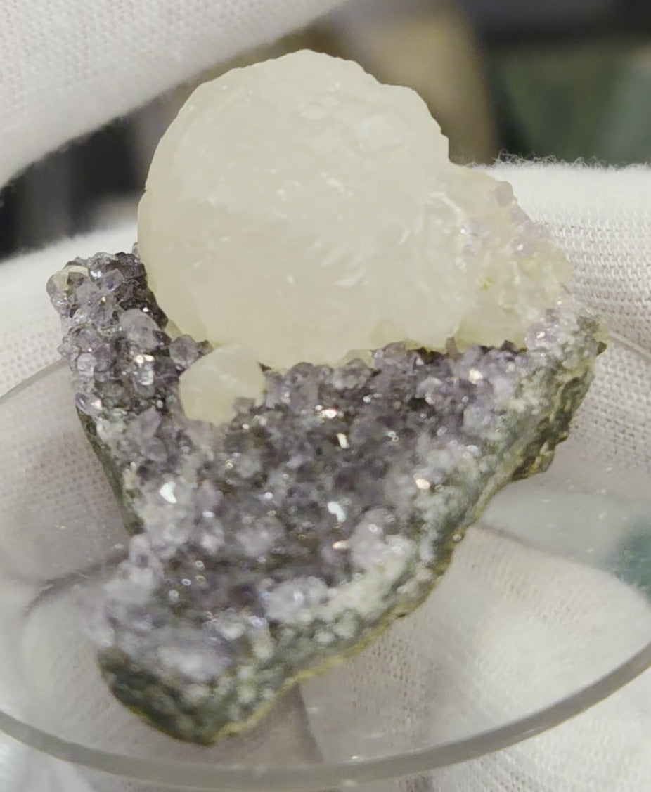 Botryoidal calcite on amethyst cluster specimen