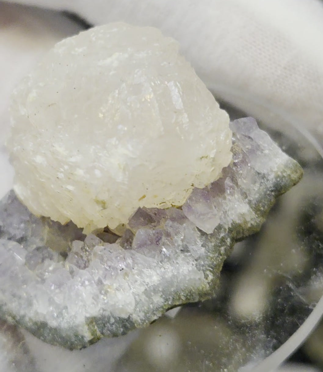 Botryoidal calcite on amethyst cluster specimen