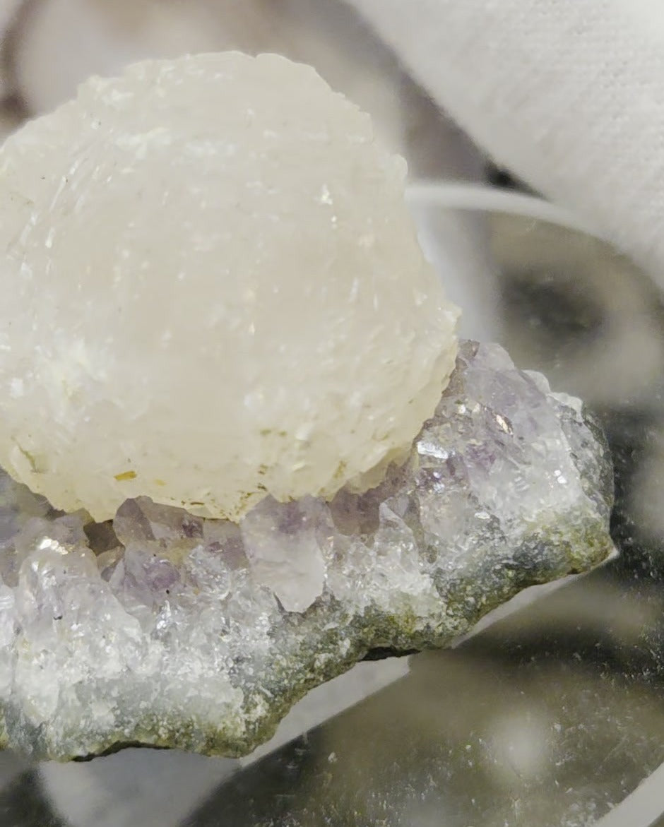 Botryoidal calcite on amethyst cluster specimen