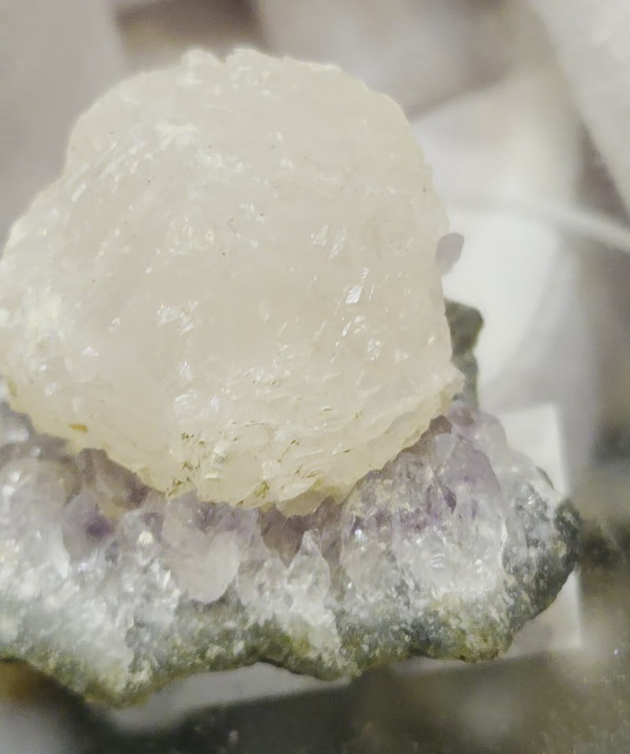 Botryoidal calcite on amethyst cluster specimen
