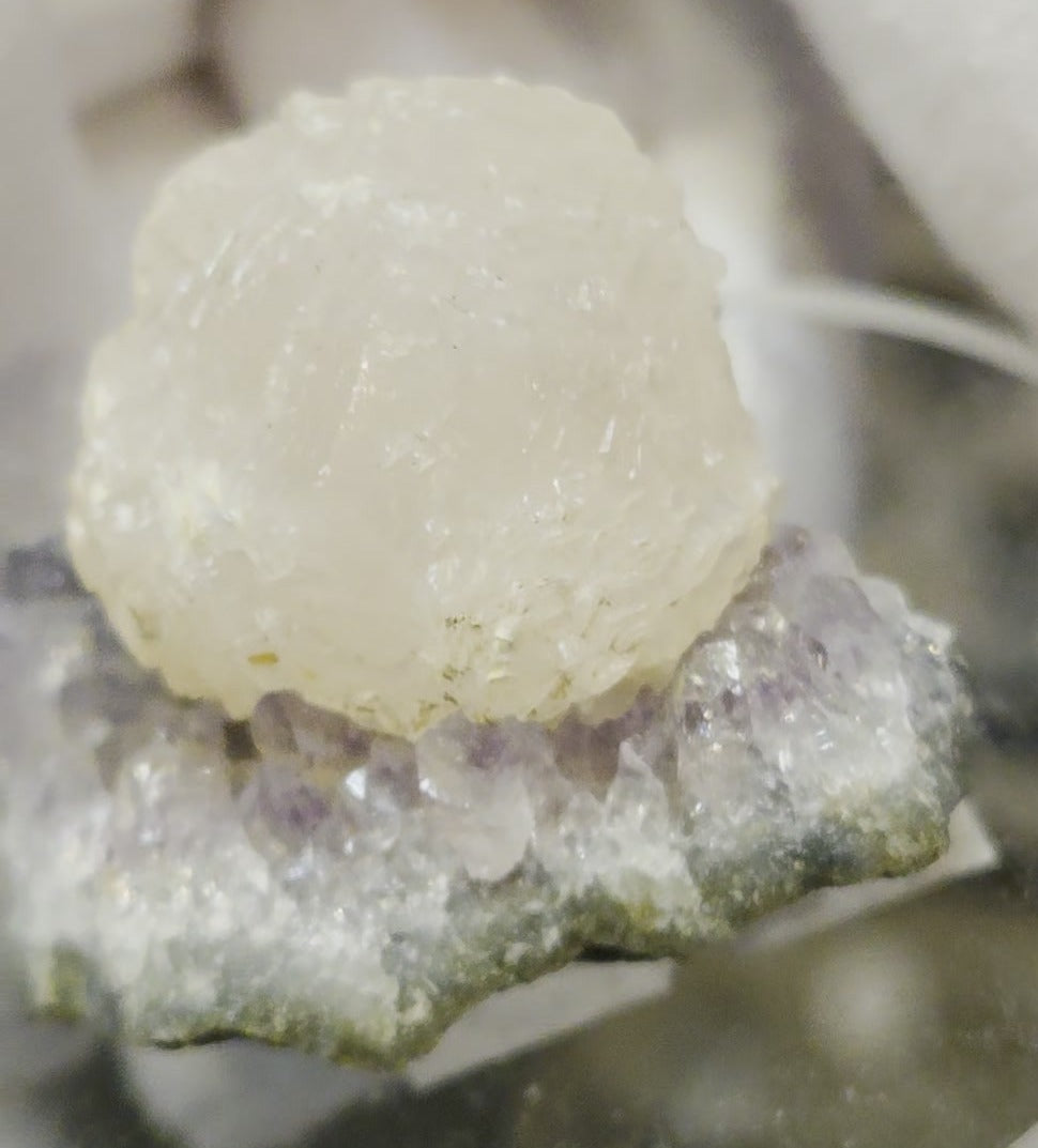 Botryoidal calcite on amethyst cluster specimen