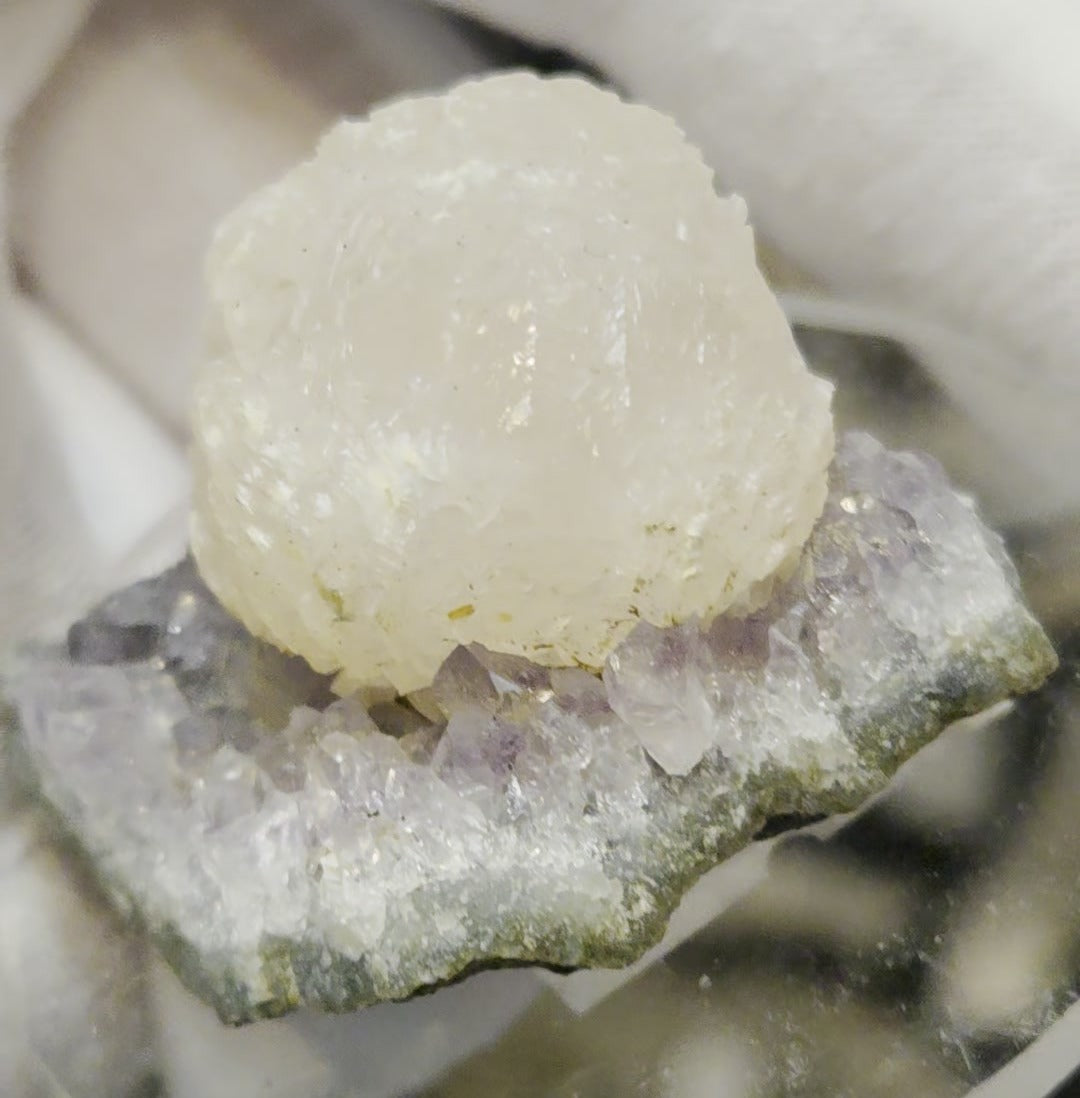 Botryoidal calcite on amethyst cluster specimen
