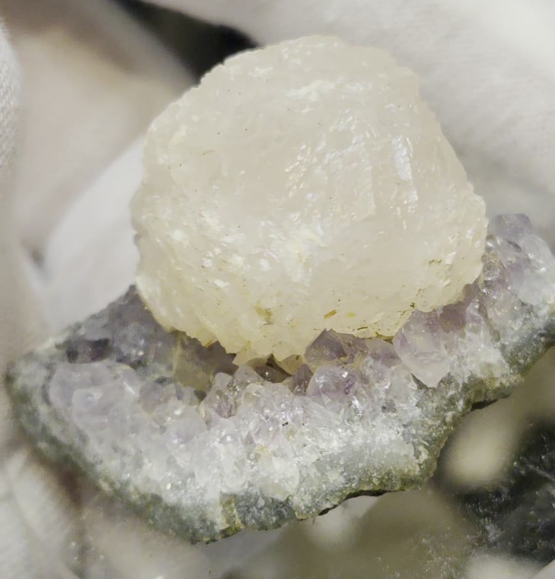 Botryoidal calcite on amethyst cluster specimen