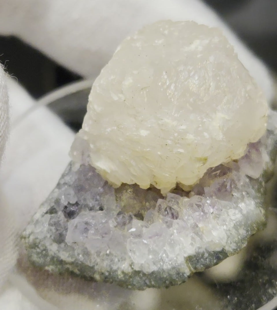 Botryoidal calcite on amethyst cluster specimen