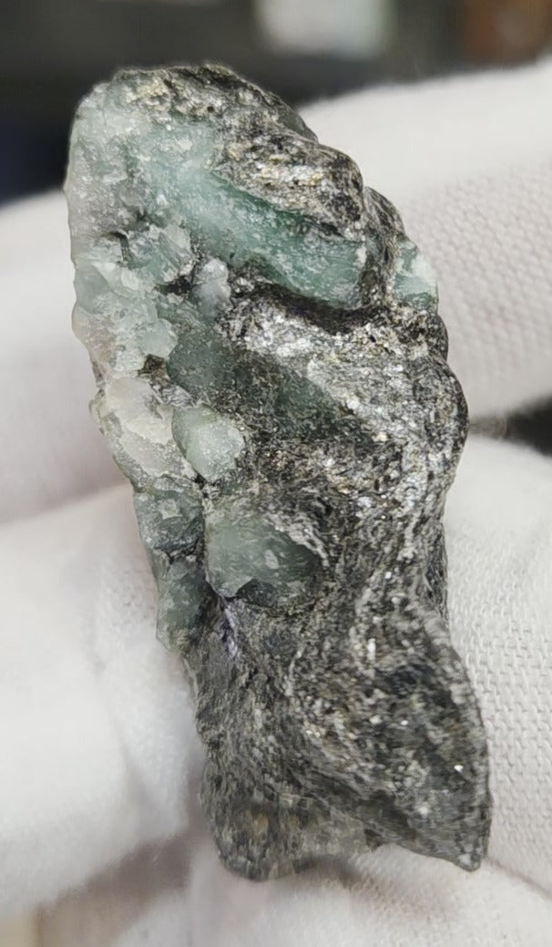 Raw green emerald on matrix specimen